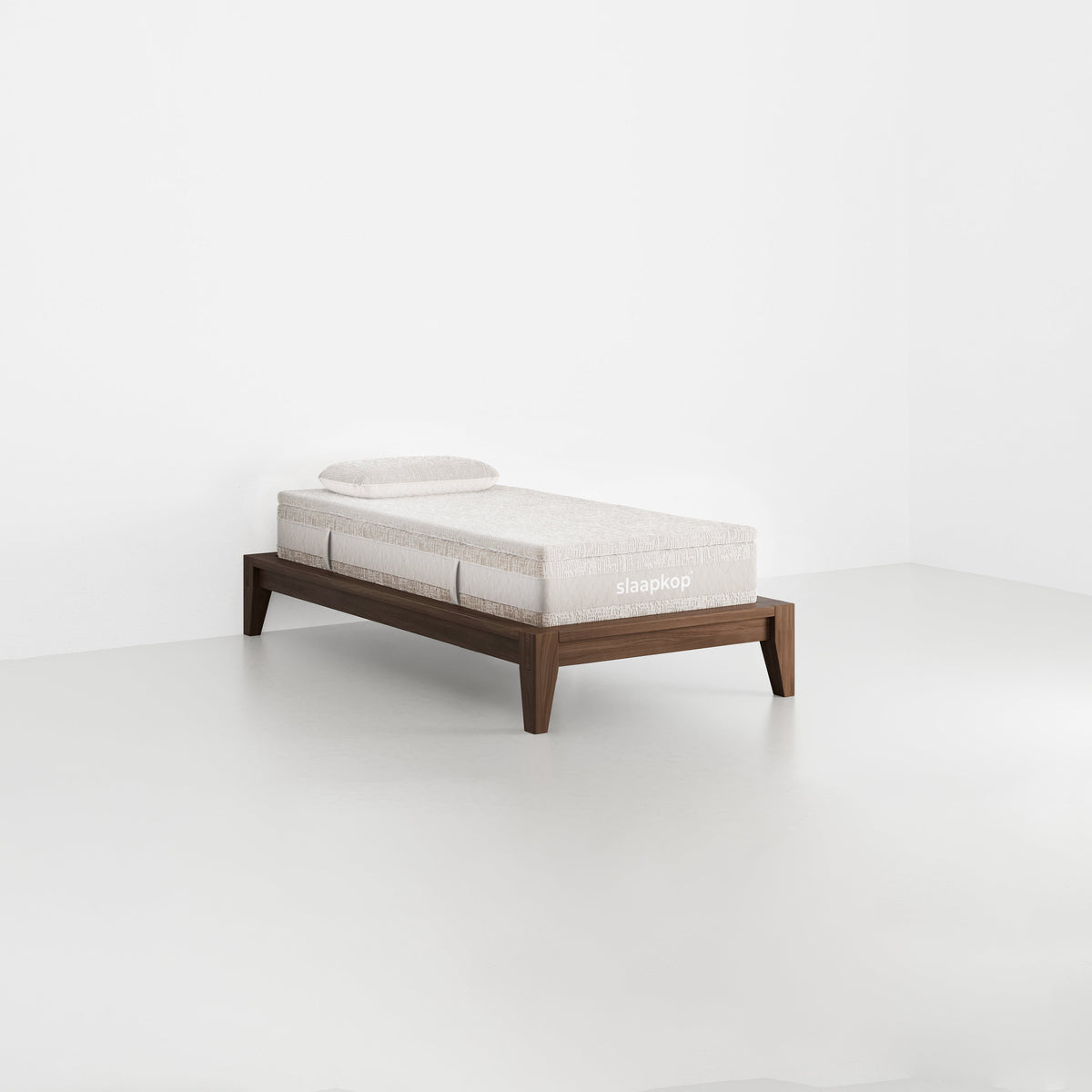slaapkop The Frame bedframe in walnut rubber wood, angled view, 90 cm width