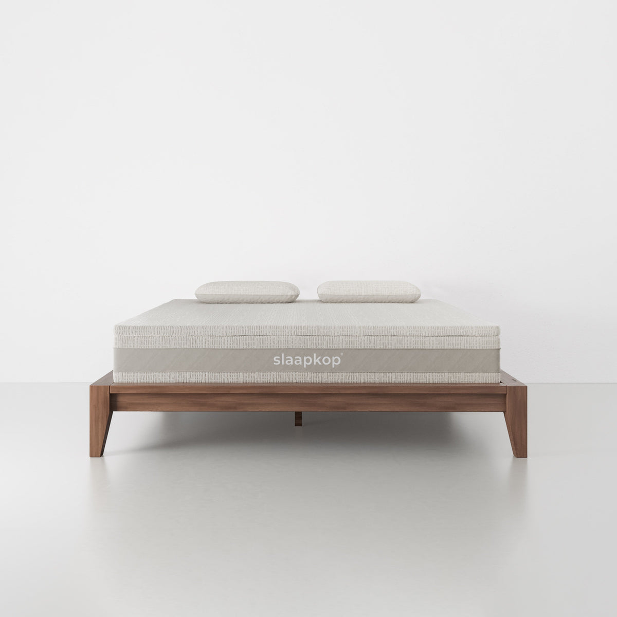 slaapkop The Frame bedframe in walnut rubber wood, front view, 180 cm width