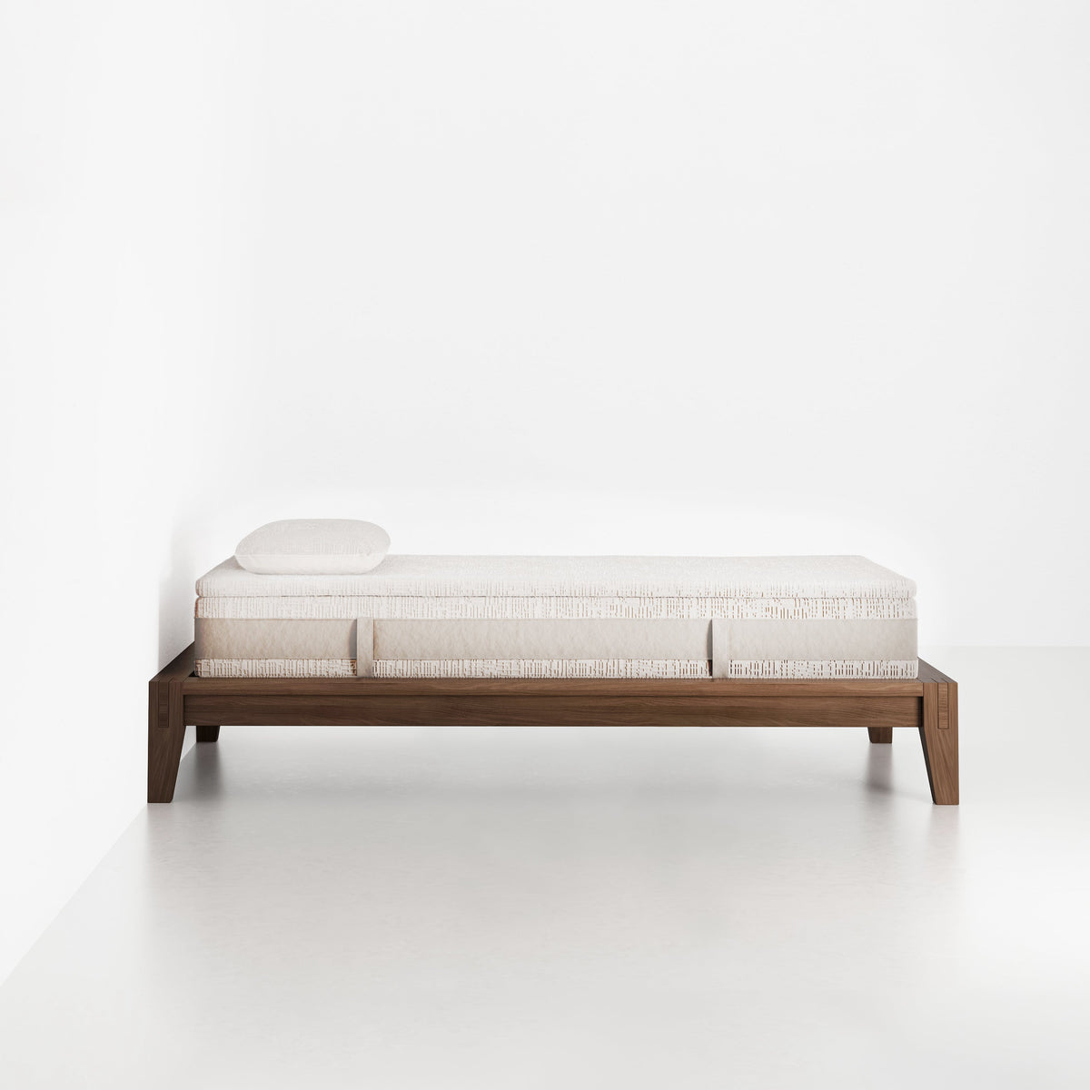 slaapkop The Frame bedframe in walnut rubber wood, side view, 90 cm width